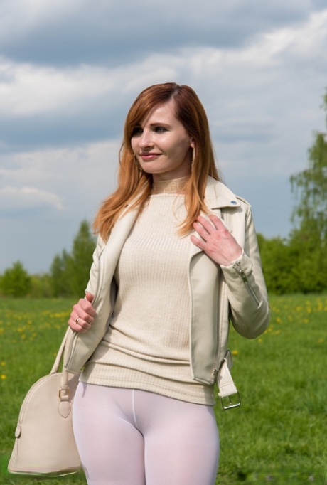 Redheaded Russian model Jeny Smith posing pantyless in pantyhose outdoors