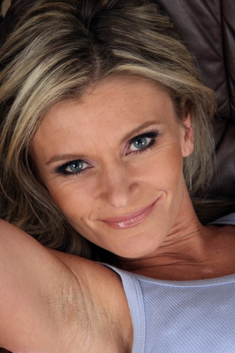 Skinny MILF Carley strips and masturbates to orgasm on the sofa