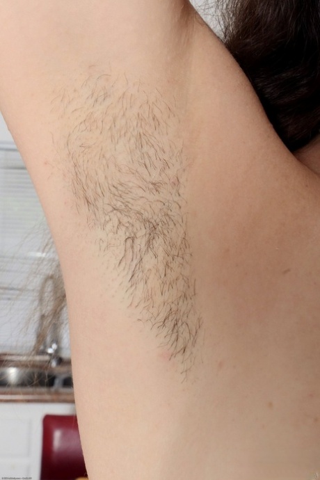 Wild amateur brunette Juliette March pulls her long pussy hair in the kitchen