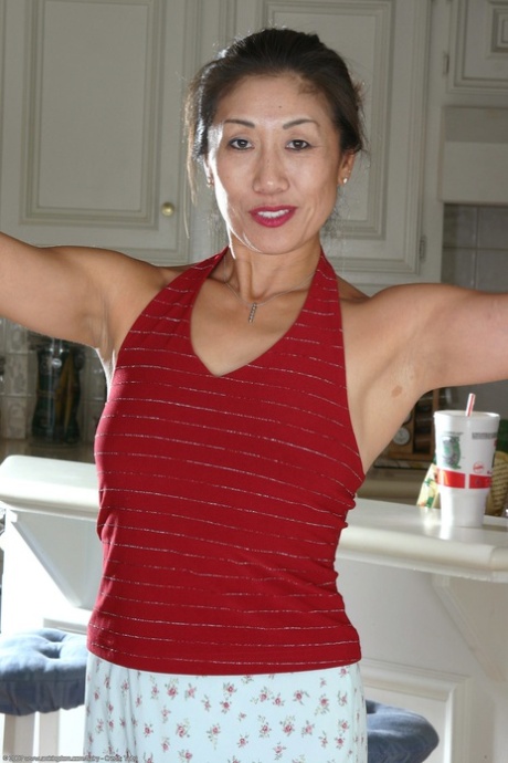 Exotic Asian MILF Hana displays her bushy beaver in a solo show