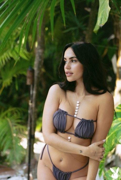 Black haired centerfold Claudia Tihan flaunts her perfect boobs in the pool